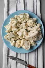 Photo of Plate with cut fresh raw cauliflower on table, top view