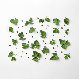 Flat lay composition with green parsley and pepper on white background