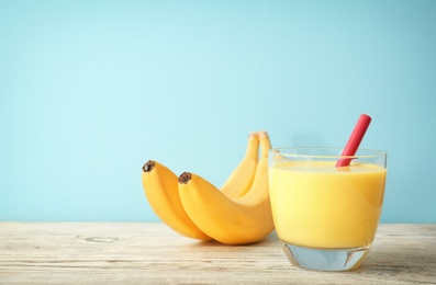 Glass with delicious detox smoothie on table