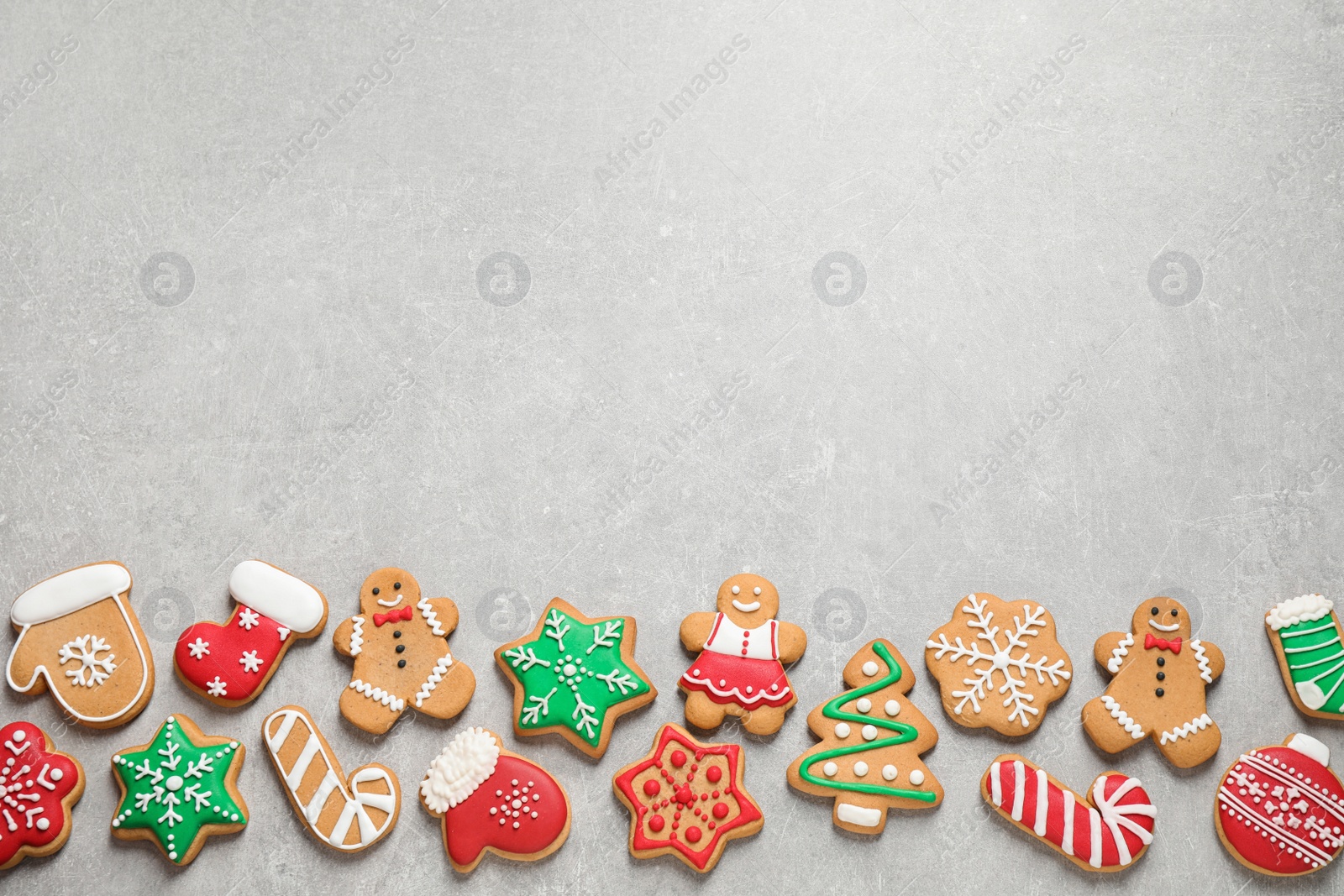 Photo of Flat lay composition with tasty homemade Christmas cookies on grey table, space for text