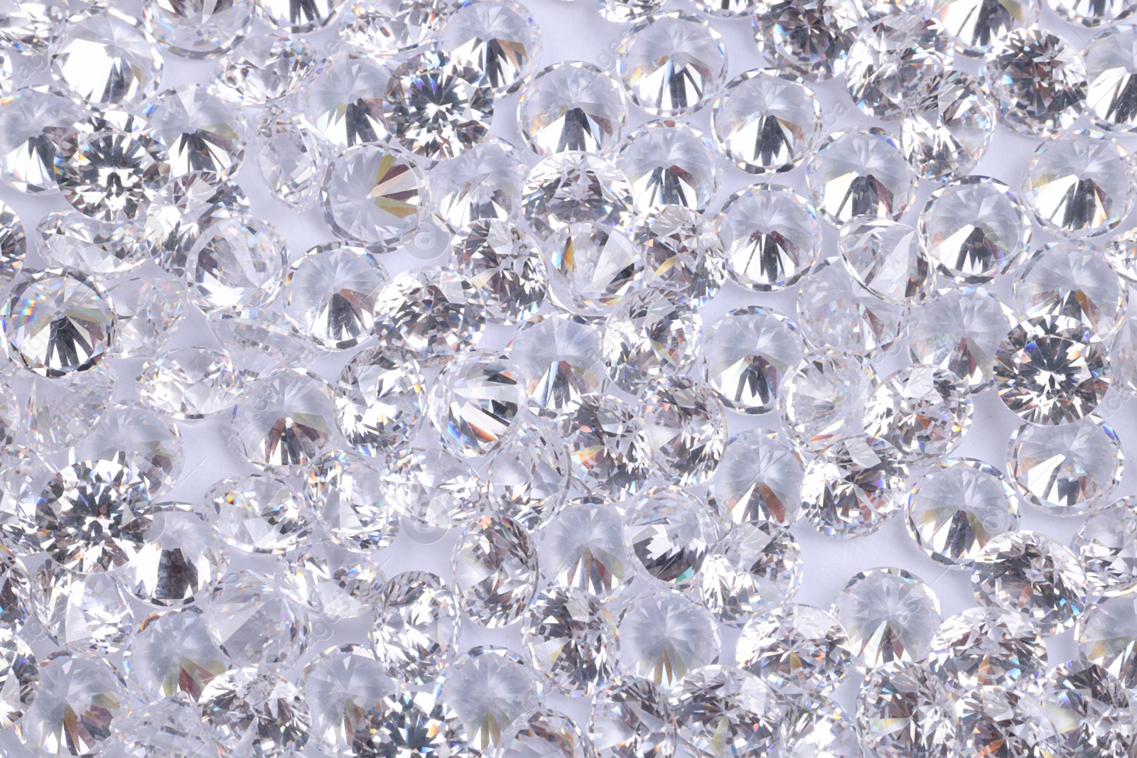 Photo of Many beautiful shiny diamonds as background, above view