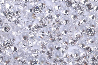 Photo of Many beautiful shiny diamonds as background, above view