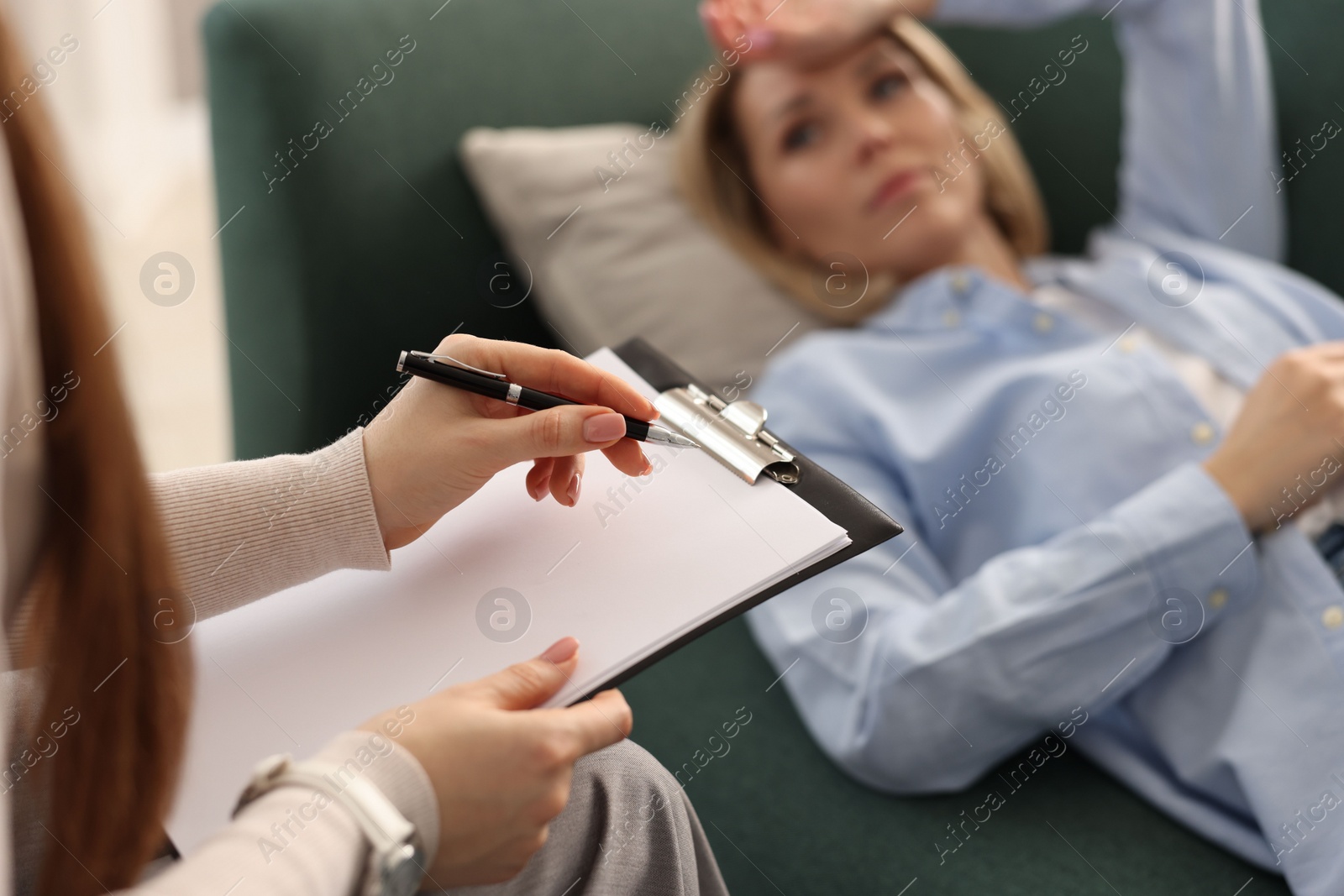 Photo of Professional psychotherapist working with patient in office