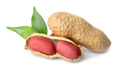 Photo of Raw peanuts and leaves on white background. Healthy snack