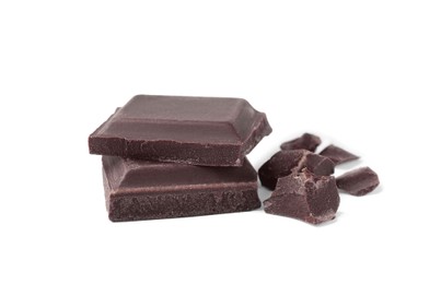 Photo of Pieces of delicious dark chocolate bar on white background