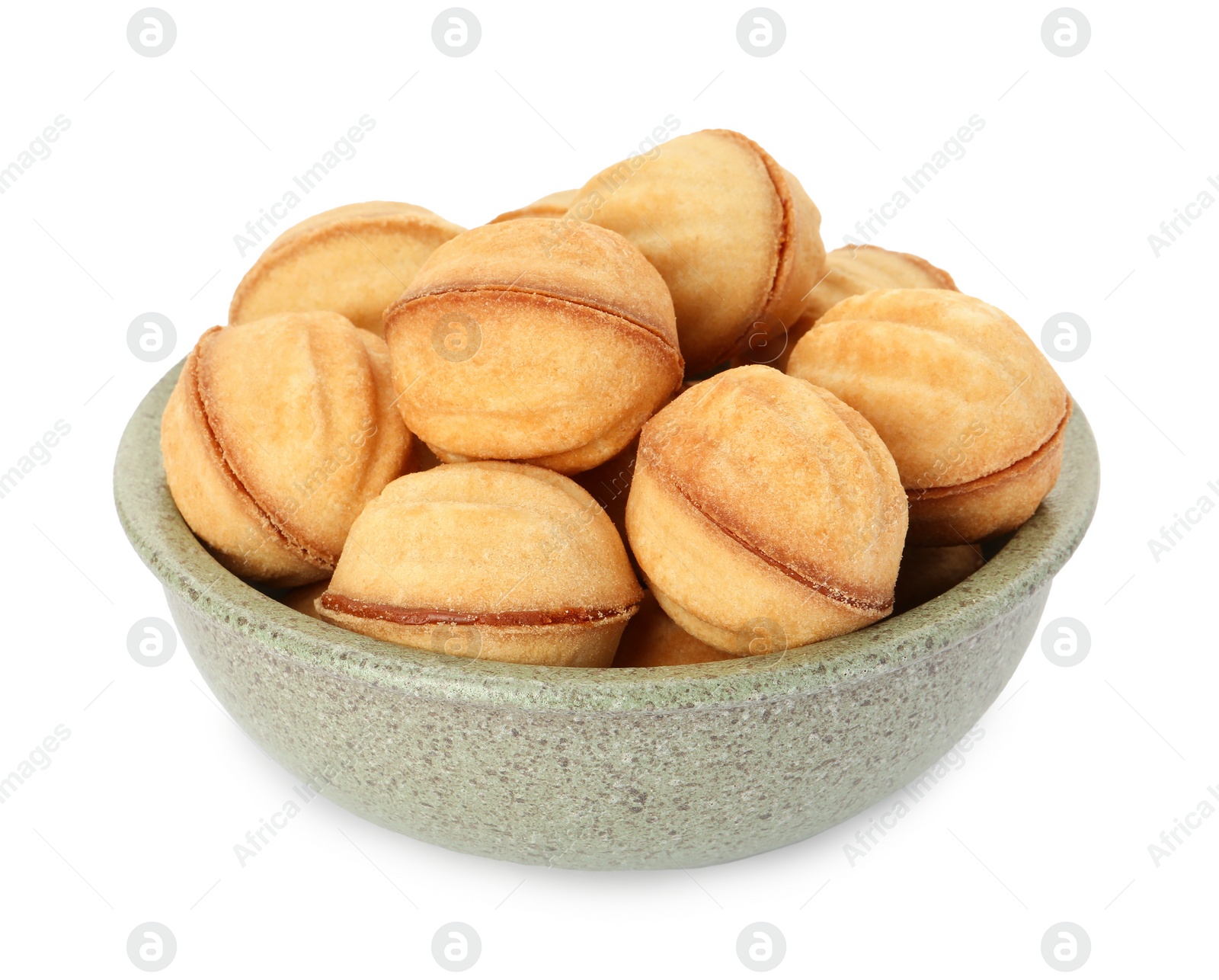 Photo of Bowl of delicious nut shaped cookies with condensed milk on white background