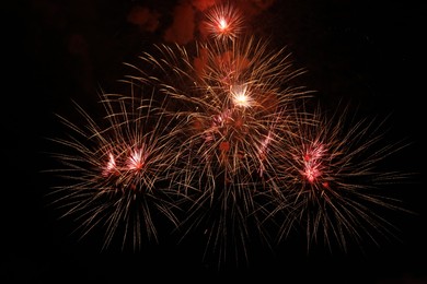 Photo of Beautiful fireworks lighting up night sky outdoors