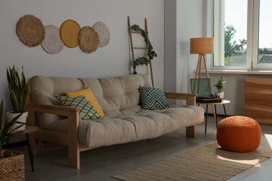 Photo of Beautiful living room interior with stylish beige sofa