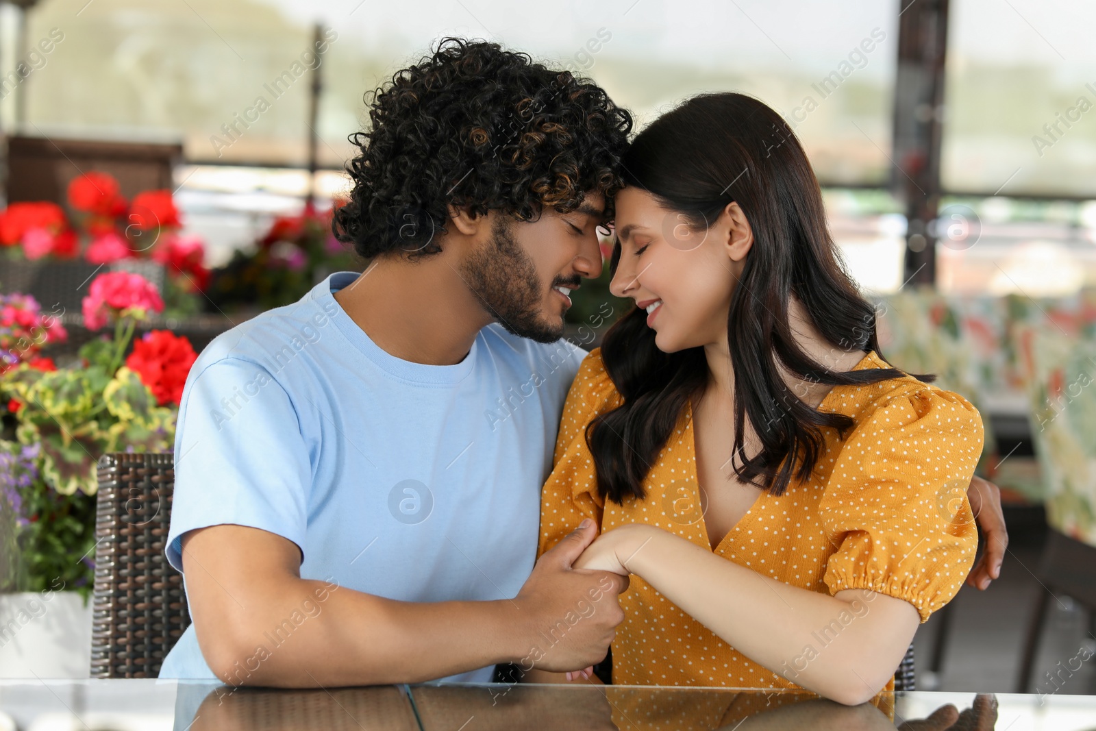 Photo of International dating. Happy couple spending time together in restaurant