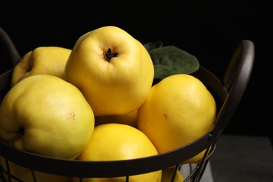 Fresh ripe organic quinces in metal basket, closeup