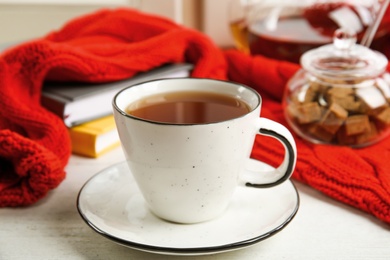 Photo of Cup of hot tea on window sill. Winter drink