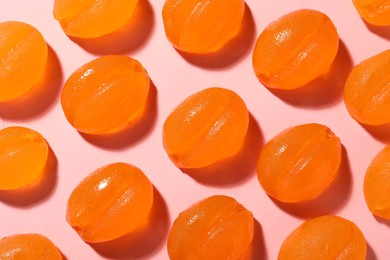 Delicious gummy candies on pink background, flat lay