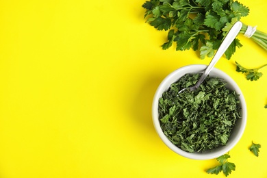 Photo of Flat lay composition with fresh and dried parsley on yellow background. Space for text