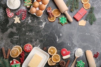 Photo of Flat lay composition with homemade Christmas cookies and ingredients on grey table, space for text