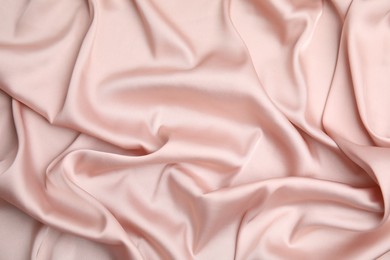 Photo of Texture of delicate pink silk as background, top view