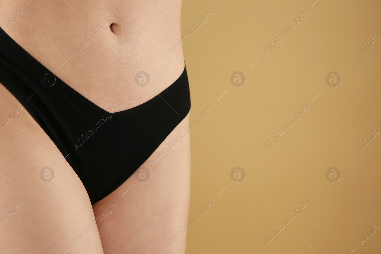 Photo of Gynecology. Woman in underwear on beige background, closeup. Space for text