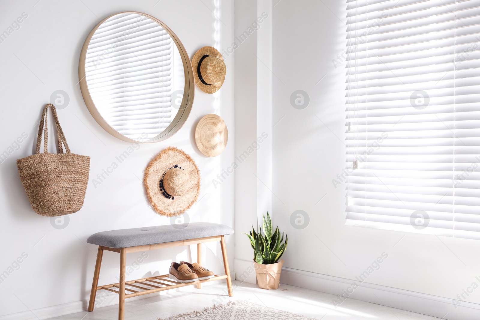 Photo of Stylish round mirror hanging on white wall in room