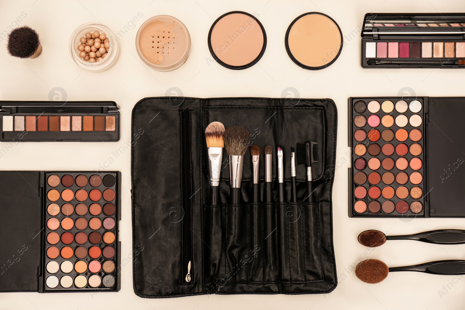 Photo of Flat lay composition with with tools and cosmetic on professional makeup artists workplace