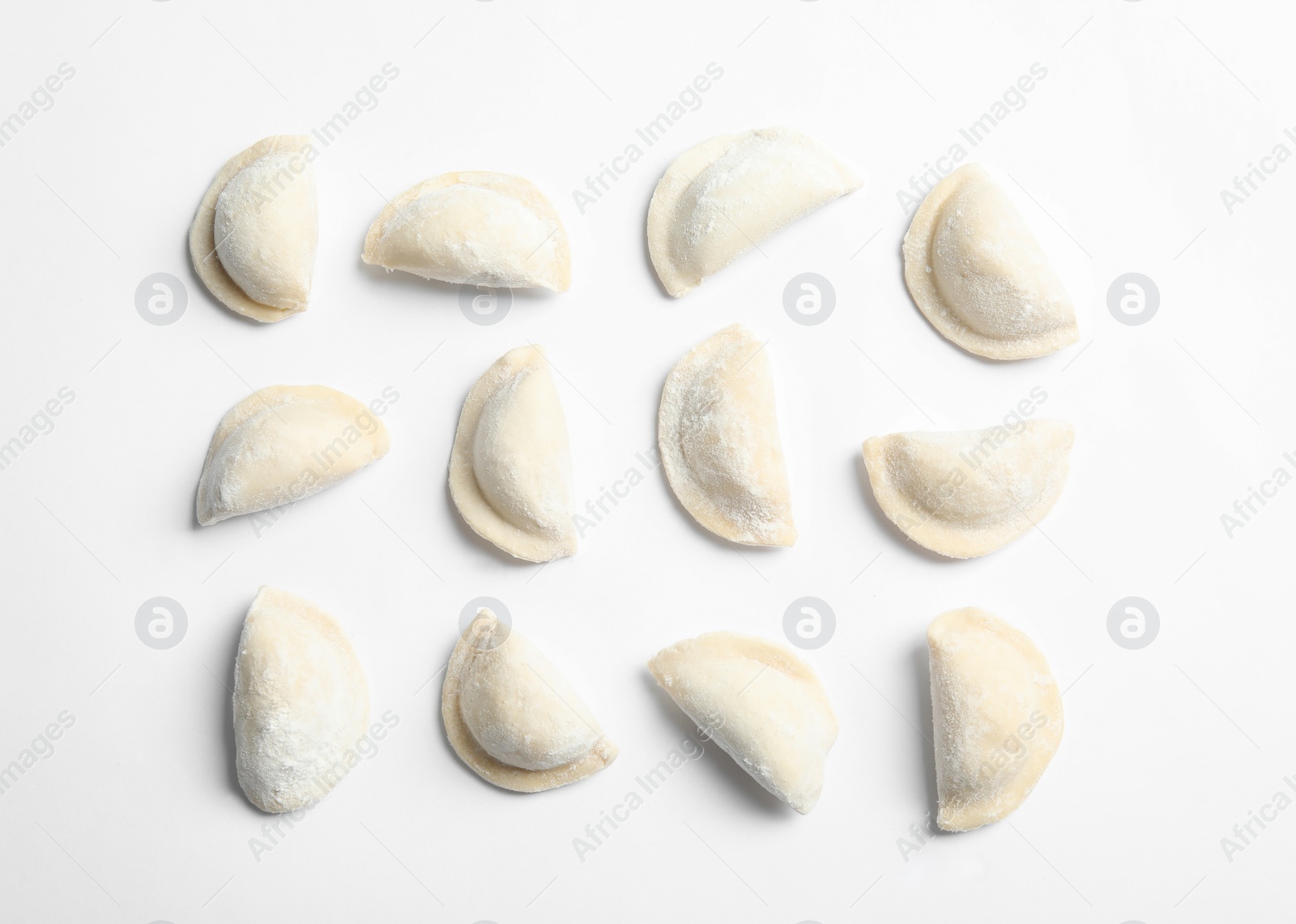 Photo of Raw dumplings on white background, top view. Home cooking