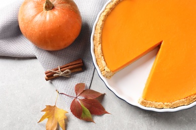 Flat lay composition with fresh delicious homemade pumpkin pie on gray table