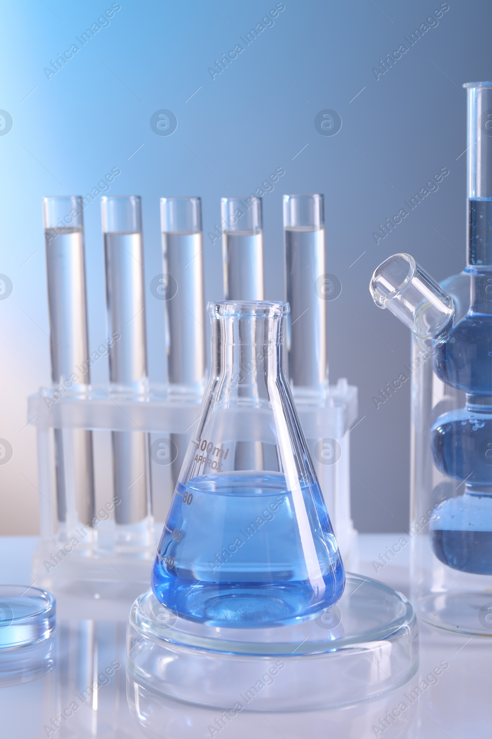 Photo of Laboratory analysis. Different glassware on table against light background