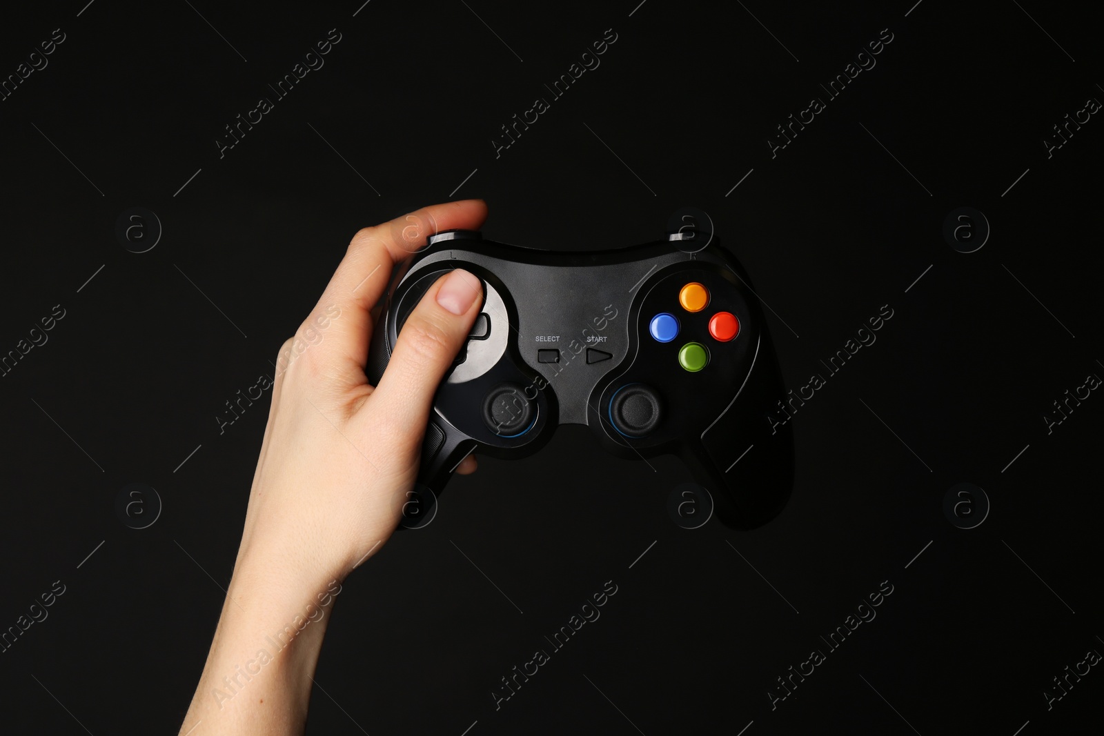 Photo of Woman with game controller on black background, closeup