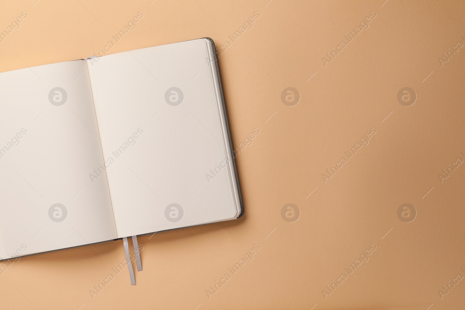 Photo of Blank notebook on beige background, top view. Space for text