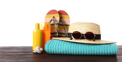 Composition with different beach objects on wooden table, white background