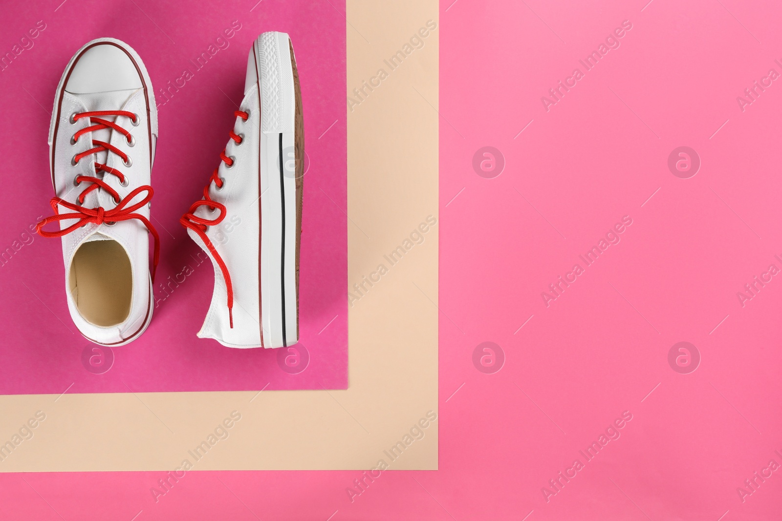 Photo of Pair of trendy sneakers on pink background, flat lay. Space for text