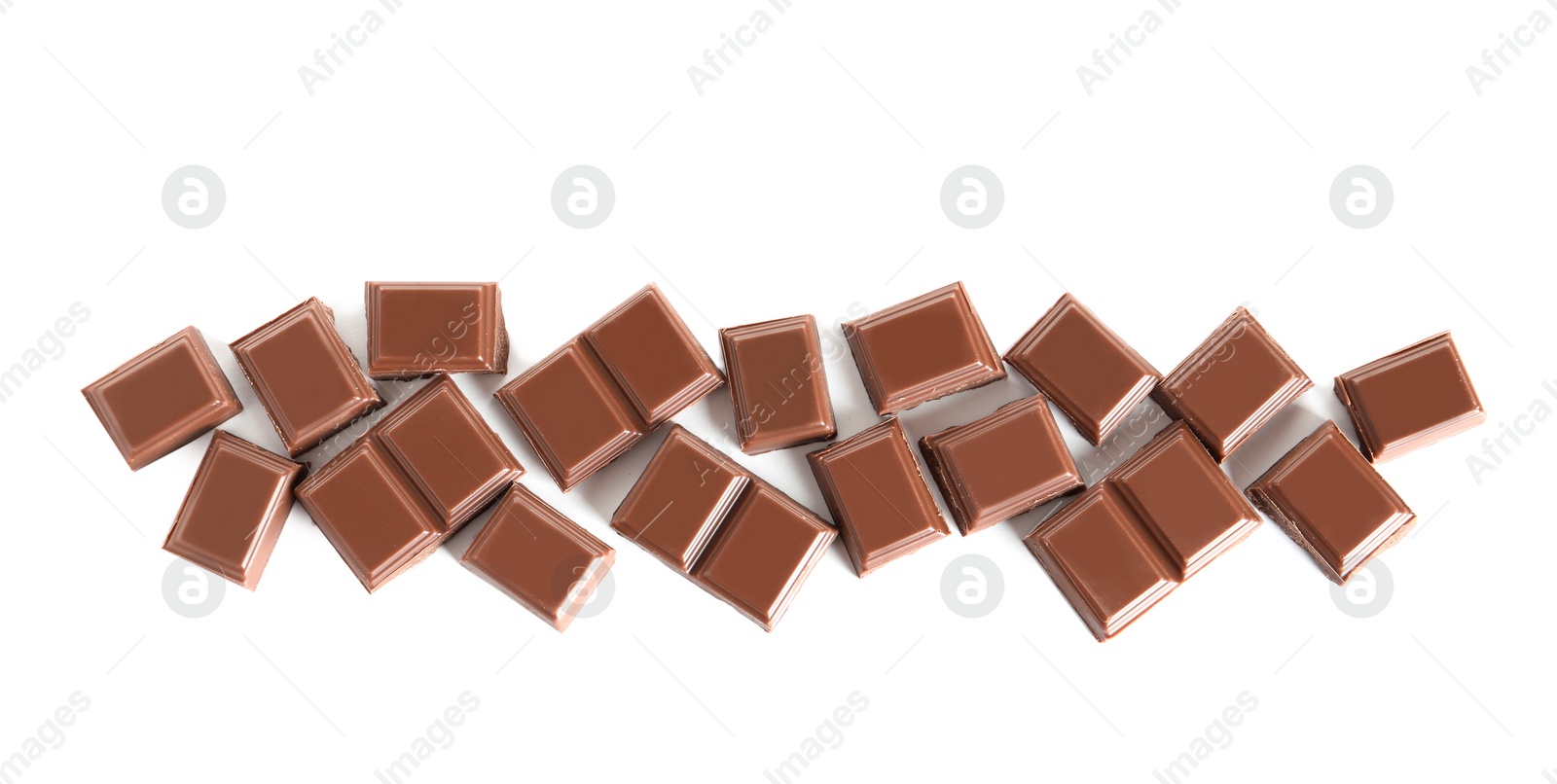 Photo of Pieces of tasty milk chocolate on white background, top view