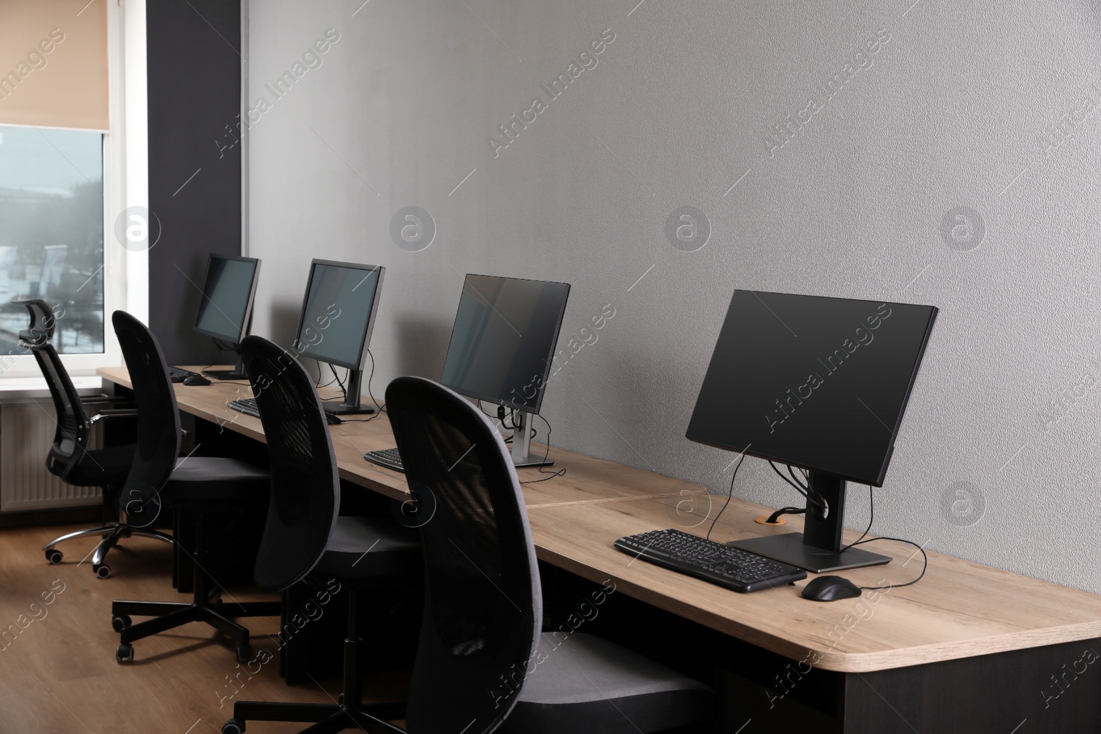 Photo of Many modern computers in open space office