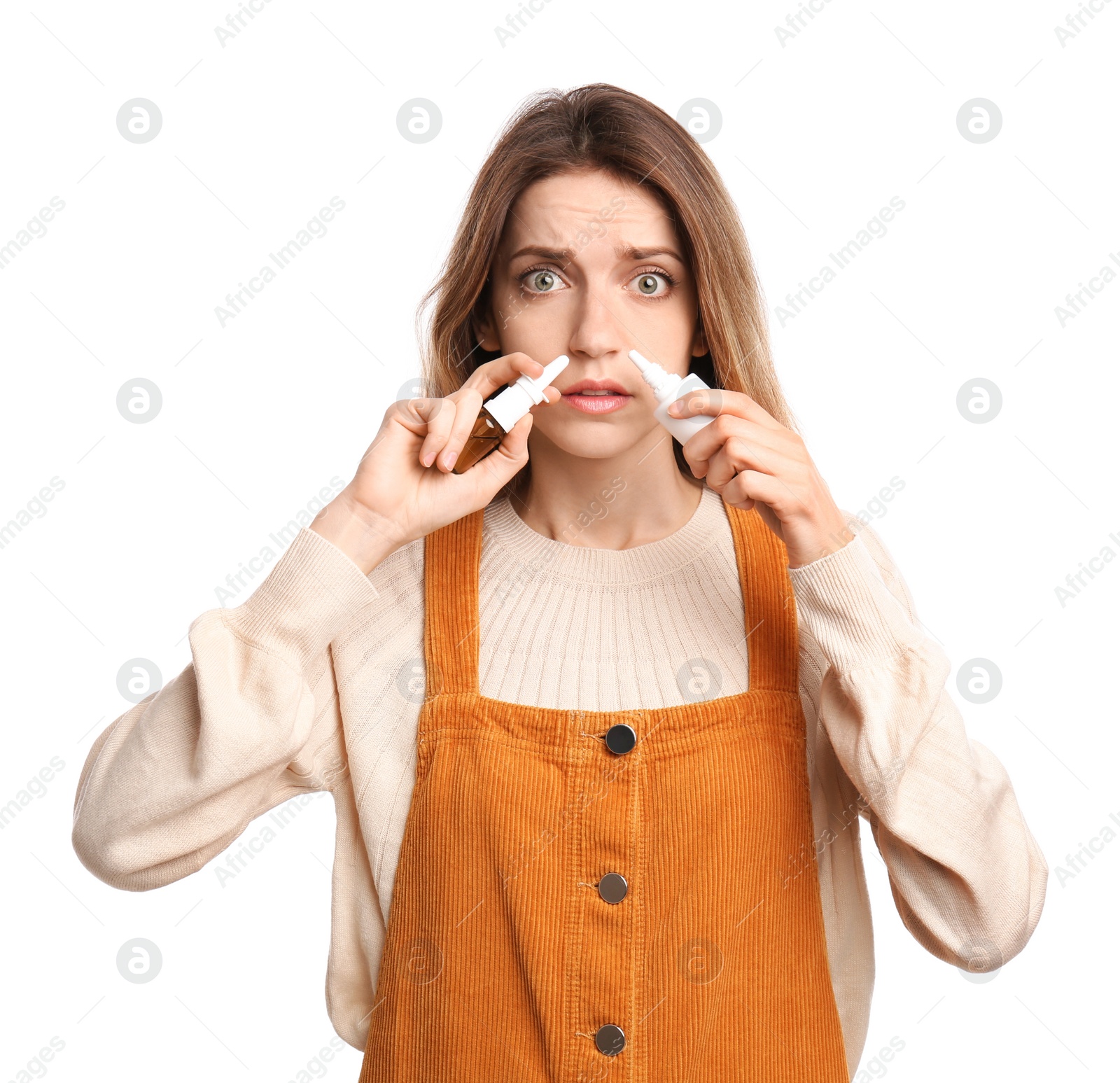 Photo of Sick young woman using nasal sprays on white background
