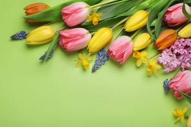 Beautiful different flowers on green background, flat lay. Space for text