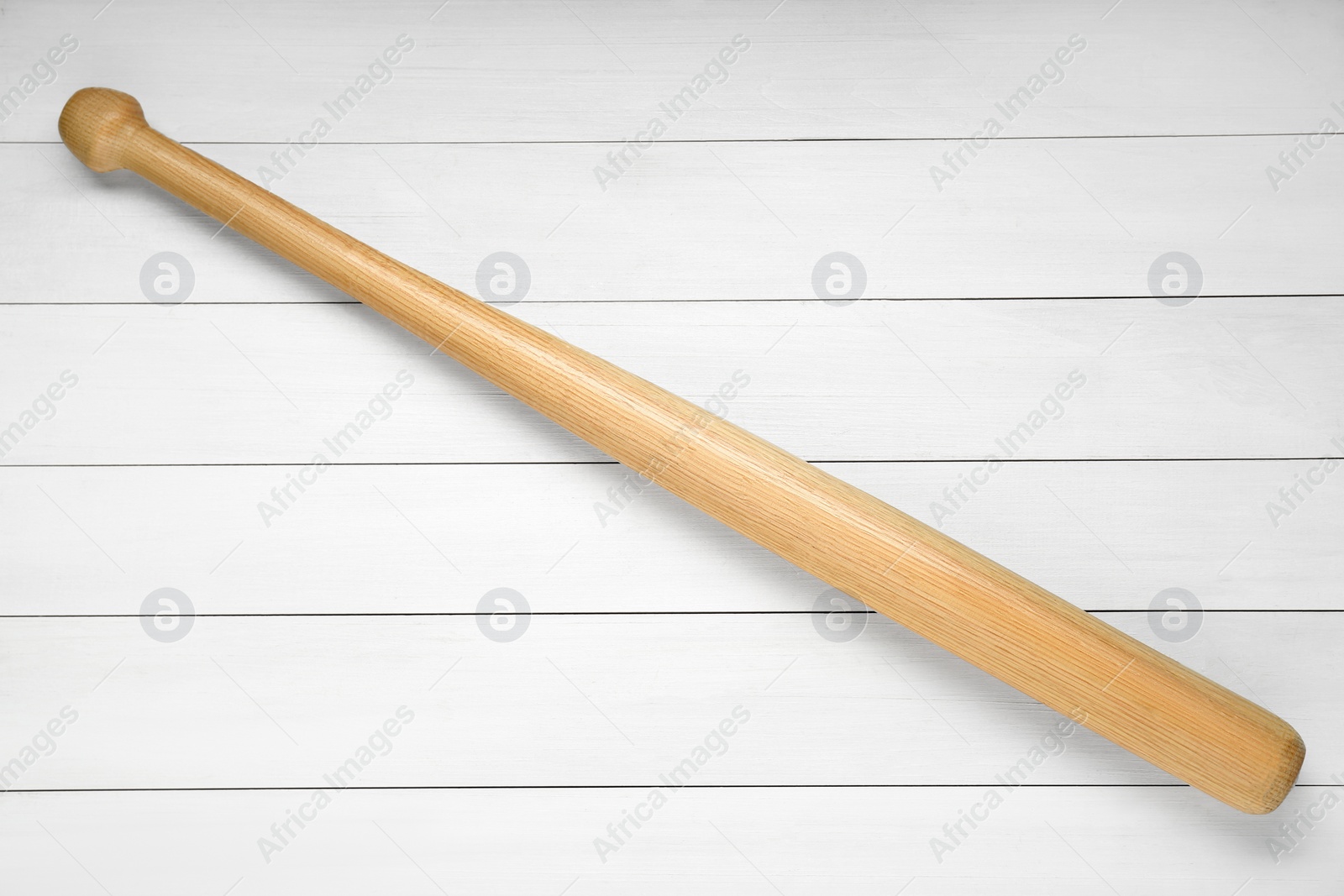 Photo of Baseball bat on white wooden table, top view. Sports equipment