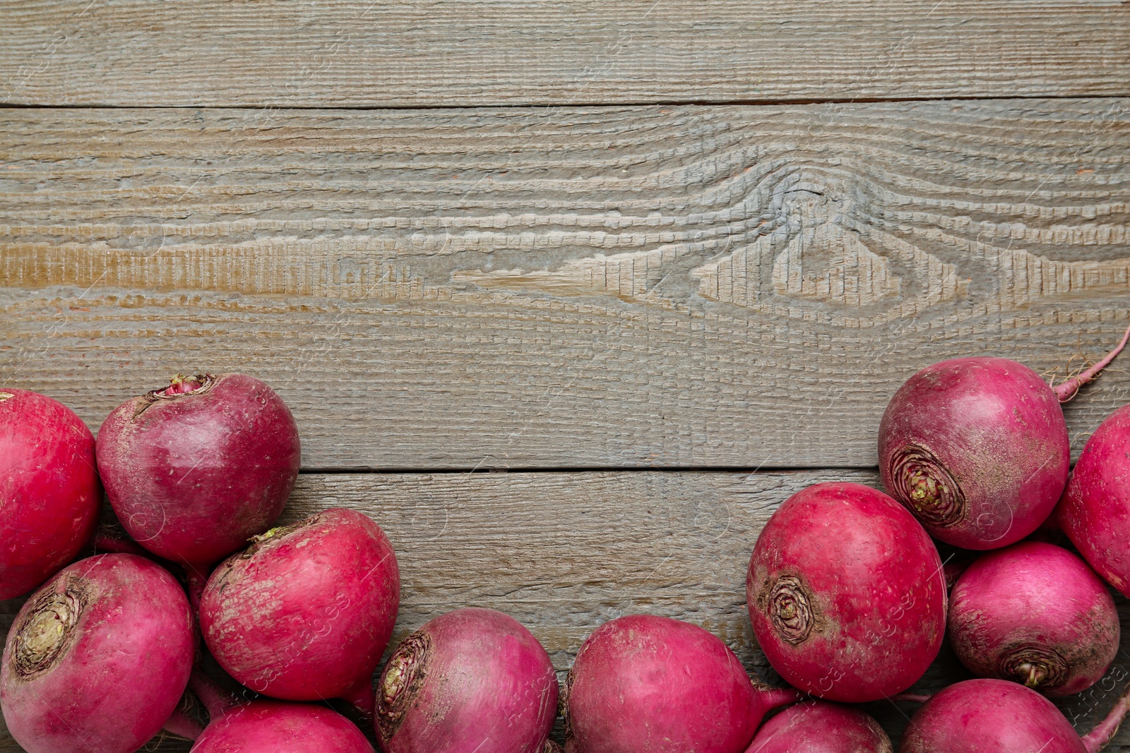 Photo of Red turnips on wooden table, flat lay. Space for text