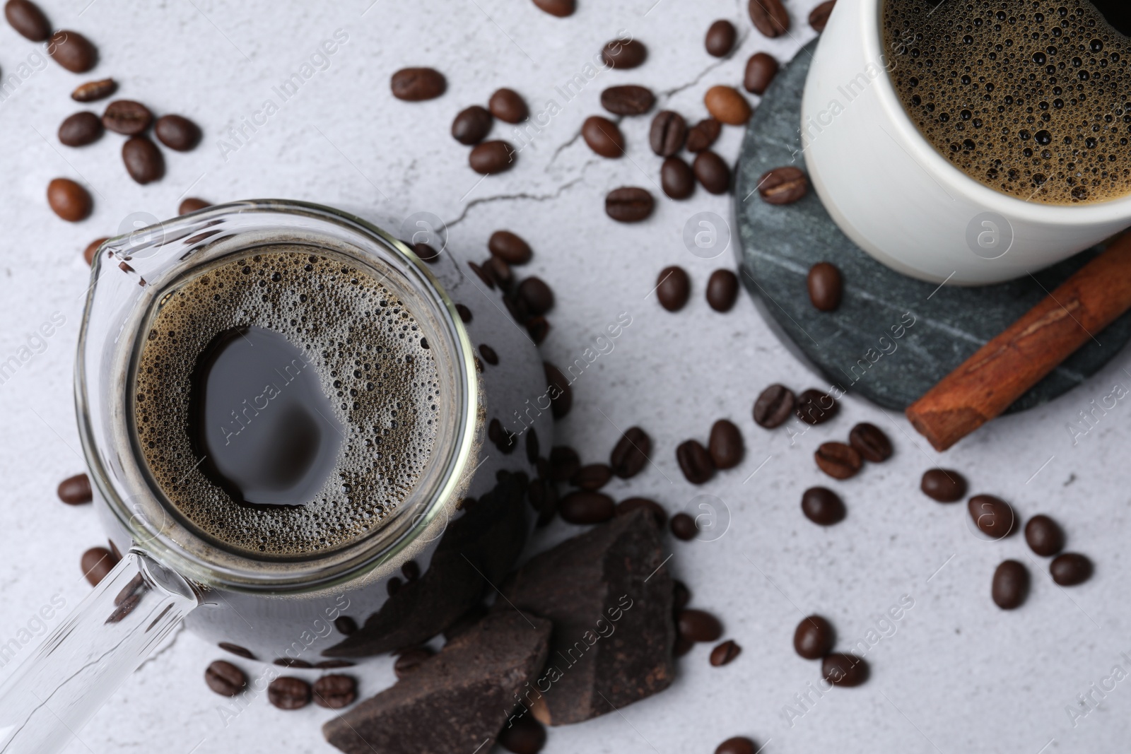 Photo of Turkish coffee. Flat lay composition with cezve and beans on light grey table