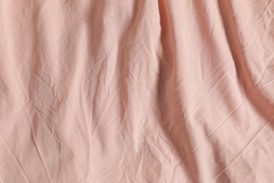 Photo of Crumpled pink fabric as background, top view