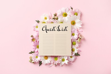 Image of Beautiful chamomile flowers and guest list on pink background, flat lay