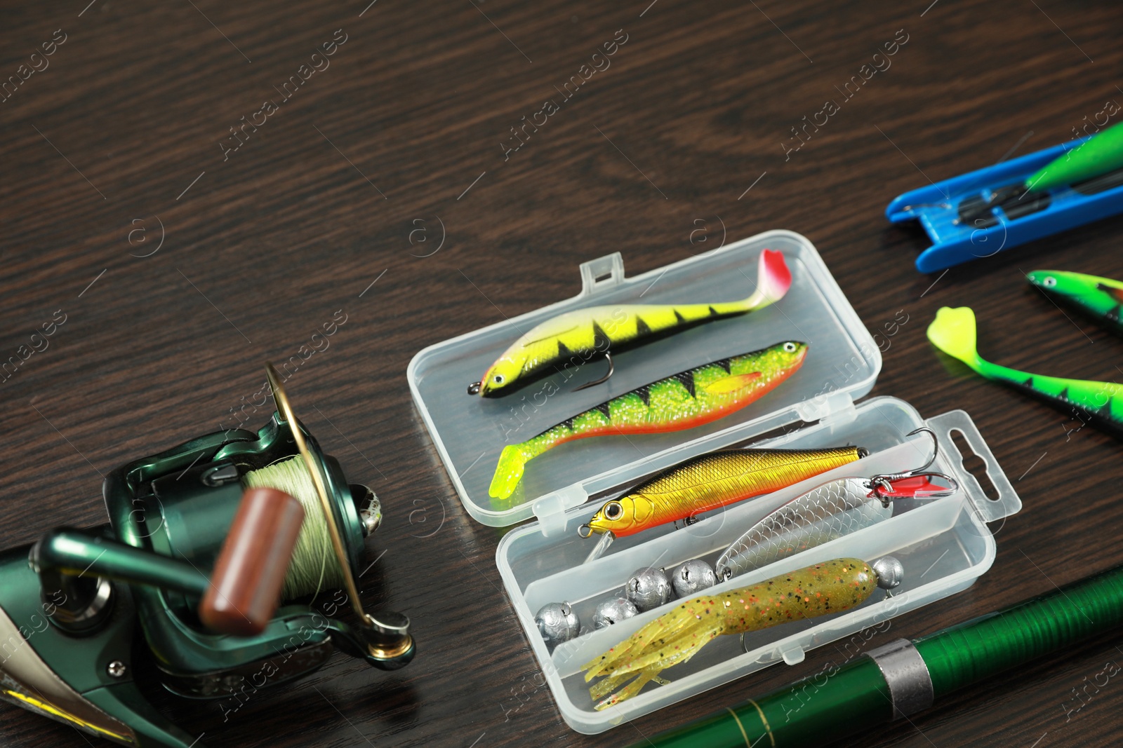 Photo of Fishing tackle on dark wooden background, space for text