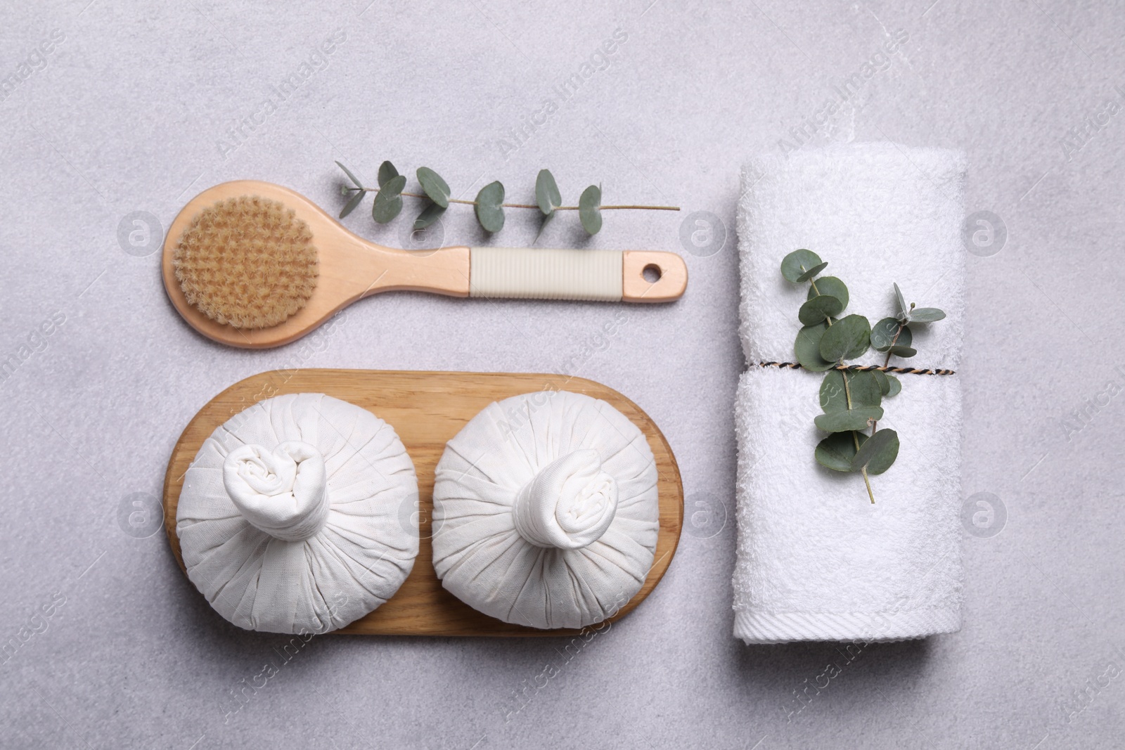 Photo of Flat lay composition with spa products and eucalyptus branches on grey table