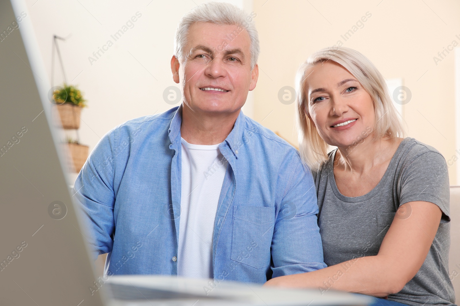 Photo of Mature couple using video chat at home