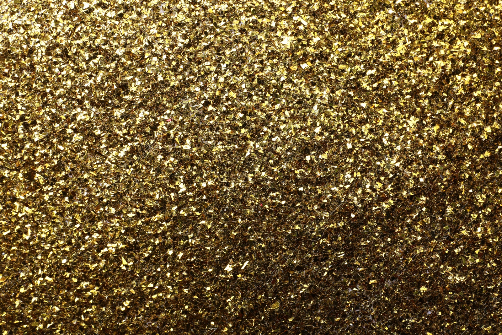 Photo of Beautiful shiny brass glitter as background, closeup