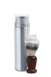 Photo of Bottle with shaving foam and brush on white background