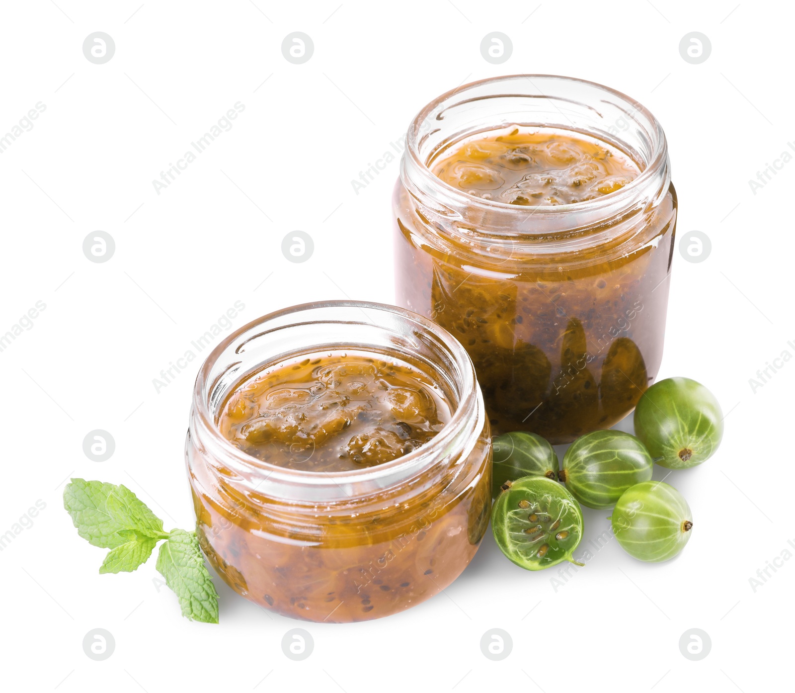 Photo of Jars of delicious gooseberry jam and fresh berries on white background