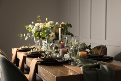 Photo of Festive table setting with beautiful floral decor indoors