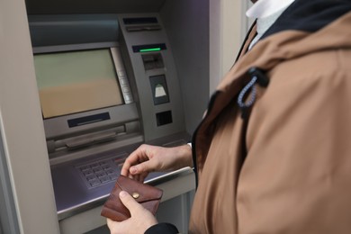 Man entering cash machine pin code, closeup