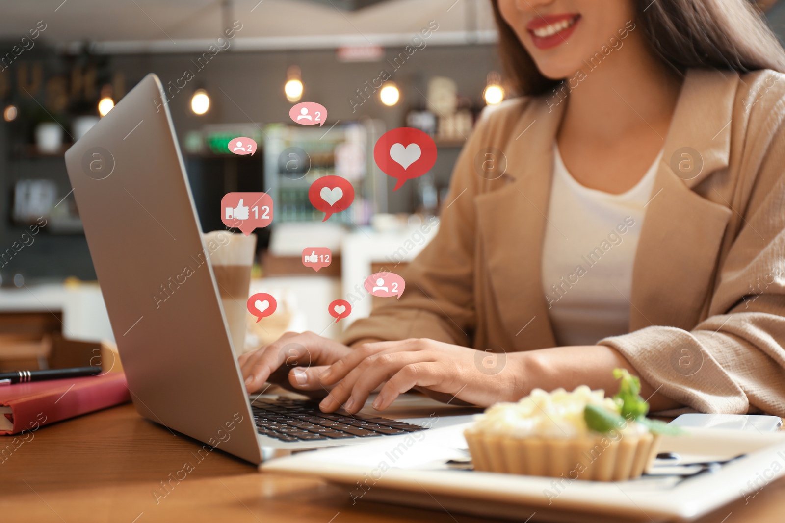 Image of Blogger working with laptop in cafe, closeup