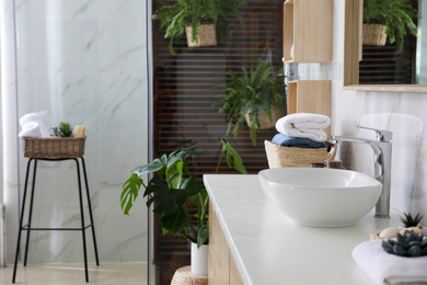 Counter with vessel sink in stylish bathroom interior. Idea for design