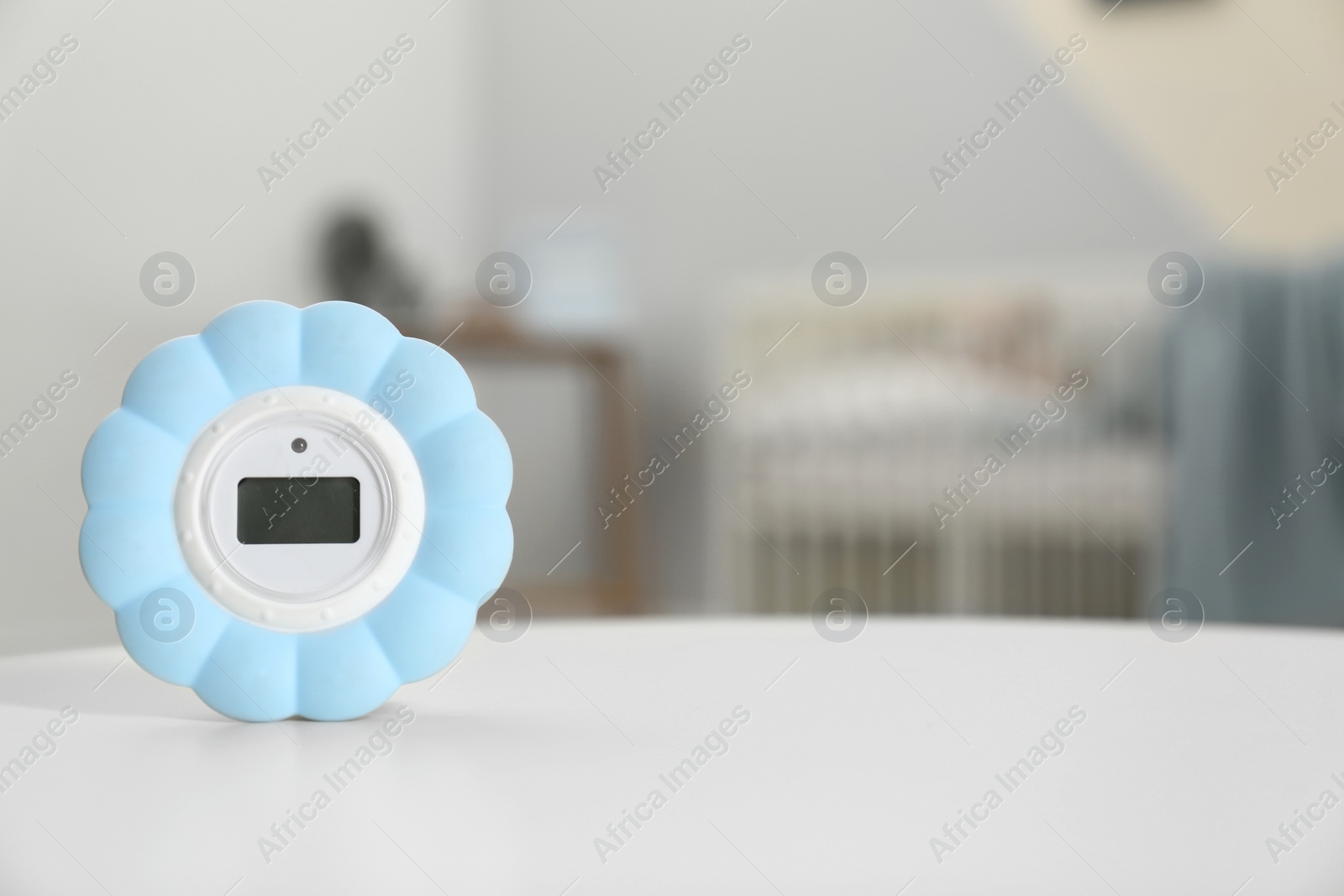 Photo of Digital temperature and humidity control in baby room interior. Space for text