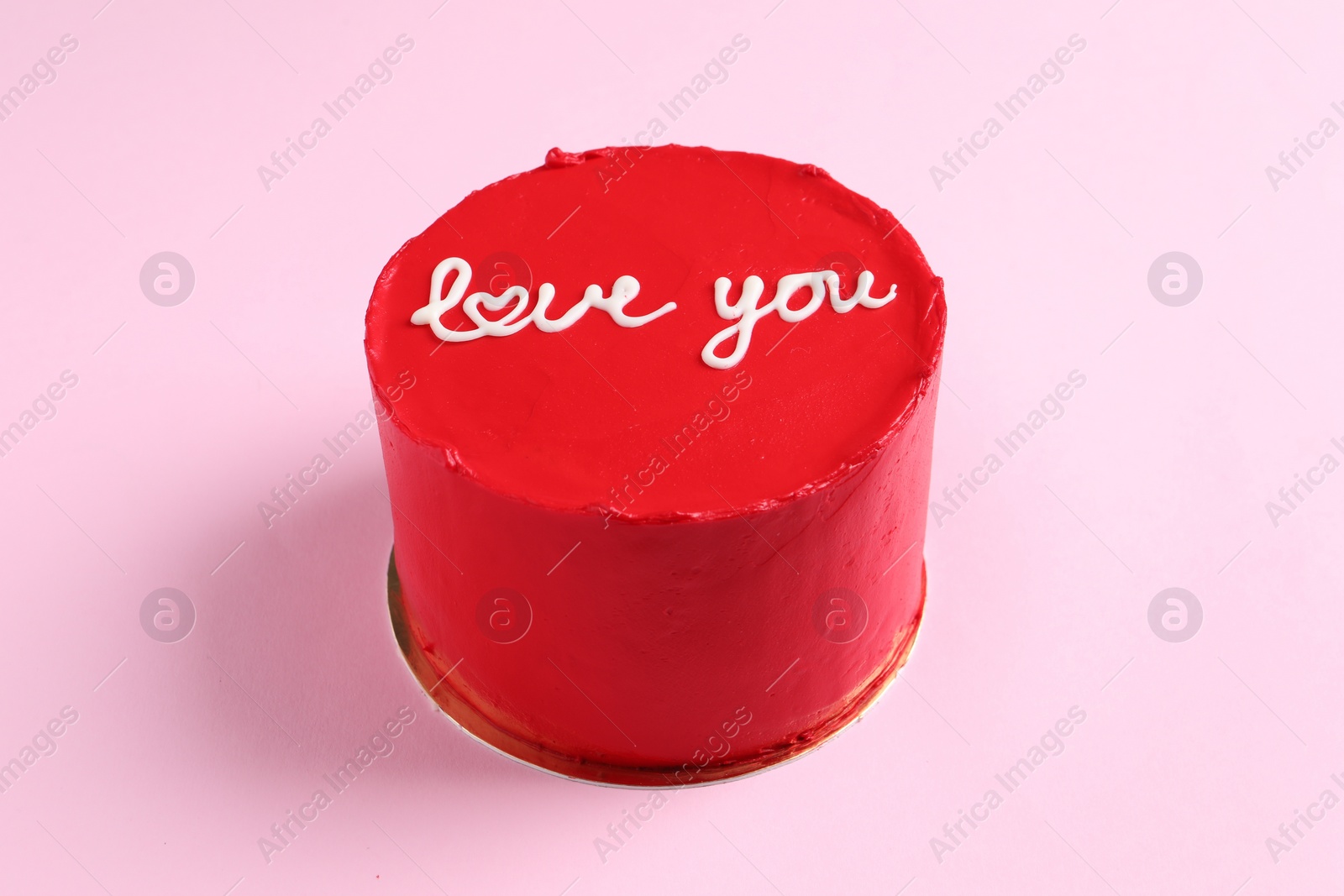 Photo of Bento cake with text Love You on pink table. St. Valentine's day surprise